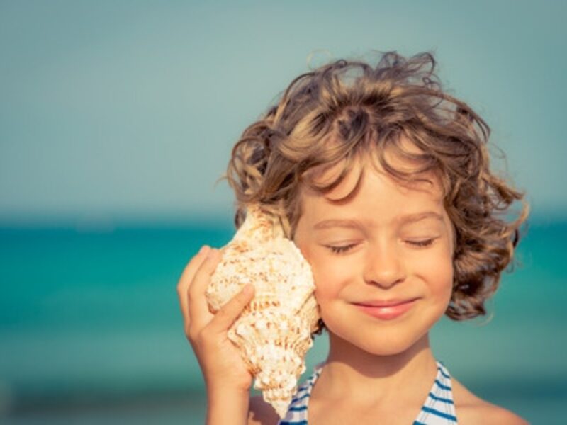 Girl Listening To Sea Shell